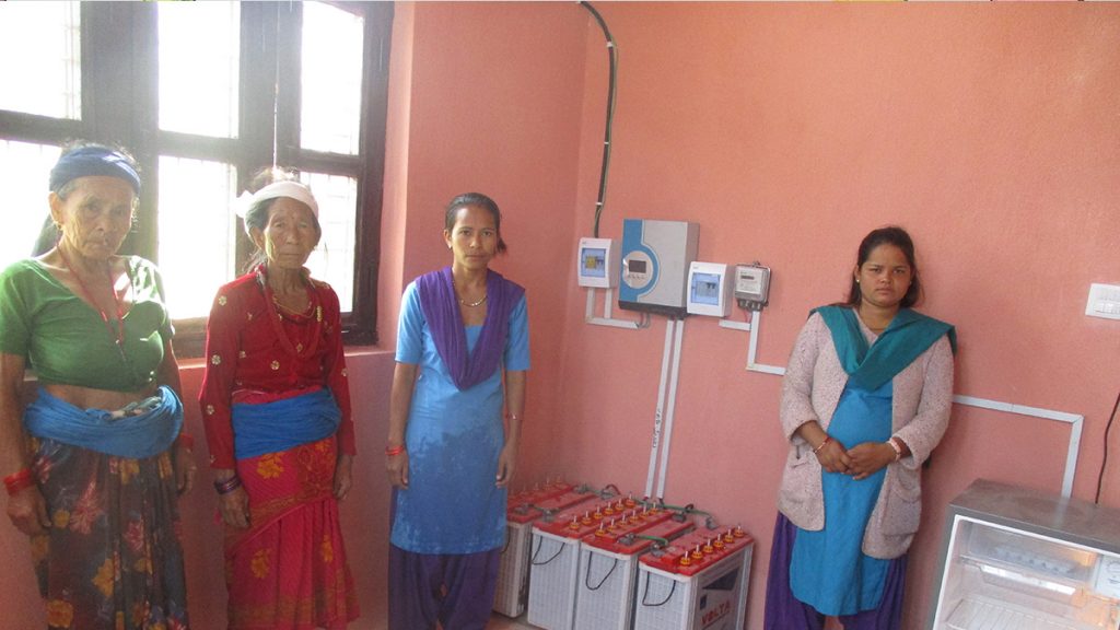 Health post workers and community members with the new solar system and fridge
