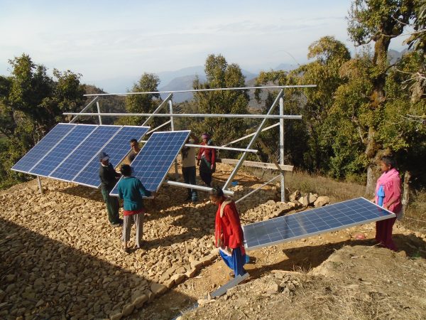 Solar panels begin to be installed by community members.